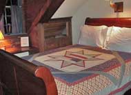 The Kedron Room has an antique queen size sleigh bed with a handmade Vermont quilt This room also has a single bed loft.